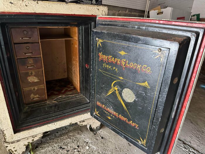 An opened remarkable antique safe with multiple small wooden drawers inside, displaying the name York Safe & Lock Co.