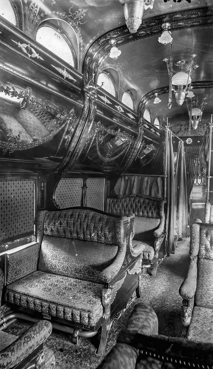 Black and white vintage photo of an ornate train car interior showing fascinating historical finds.