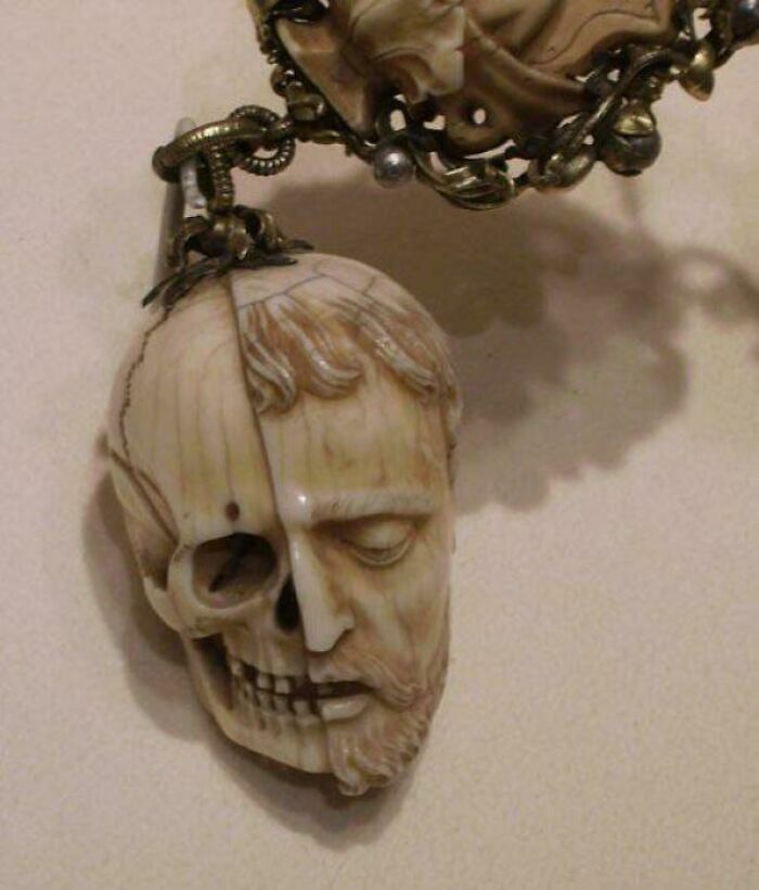 Carved ivory pendant depicting a half human face and half skull among interesting historical finds.