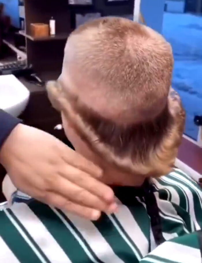 A person with an uneven, half-shaved hairstyle, highlighting a bad hair mistake in progress.