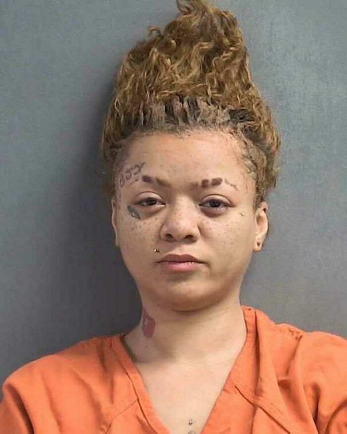 A woman with an extreme high top curly hairstyle, showcasing a bad hair mistake.