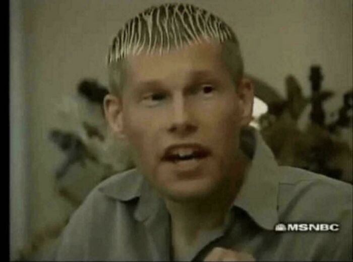 A man with spiky blonde hair, a hilariously bad hair mistake, captured in a frame.