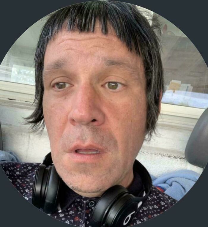 A man with extremely short bangs and longer sides, wearing headphones, highlighting a bad hair mistake.