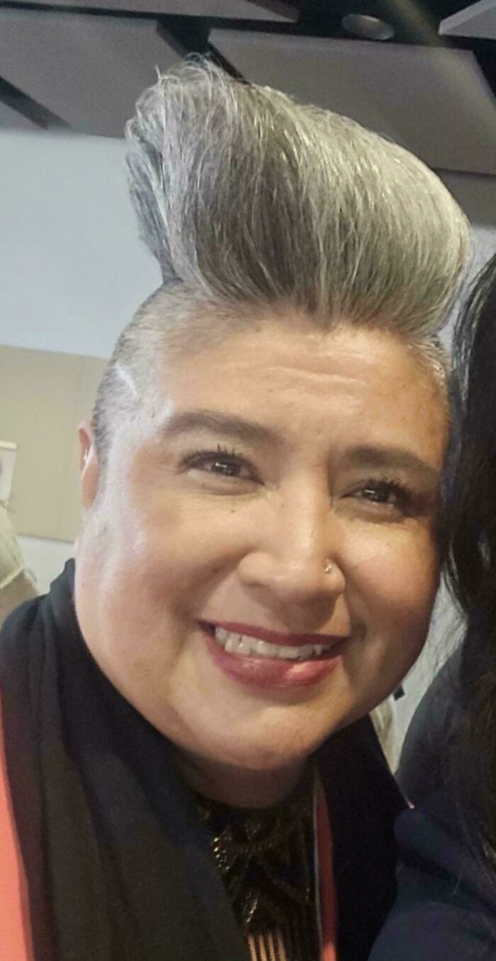 A woman with a dramatic, sky-high grey mohawk, a bold example of bad hair mistakes.