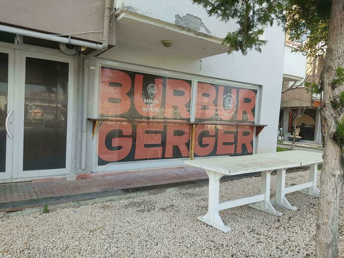 A restaurant window with 'BURBUR GERGER' written in large letters, an example of hilariously confusing sign design.