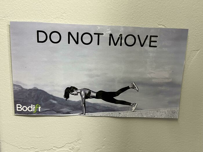 Gym sign with a person doing a plank exercise and the warning message do not move, highlighting gym safety and fitness humor.