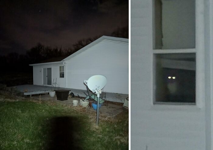 Creepy night photo of a house with glowing eyes peering from a dark window, evoking eerie and weird feelings.