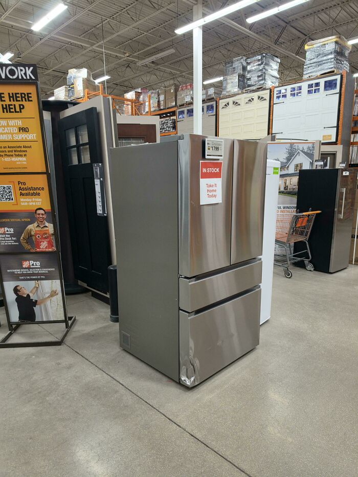 A stainless steel refrigerator on display at a Home Depot store