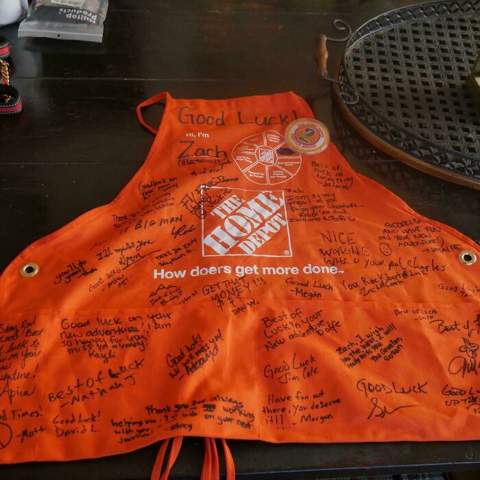 Orange Home Depot employee apron signed with farewell messages for a coworker