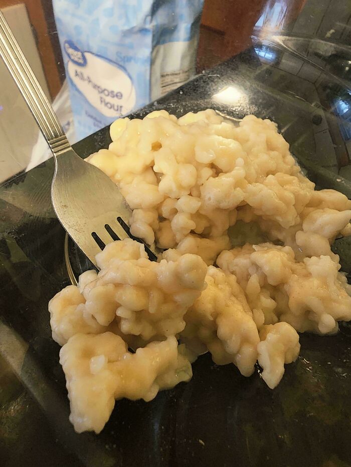 A close-up of dumplings with a fork, with an all-purpose flour bag in the background, from the Not Interesting Community.