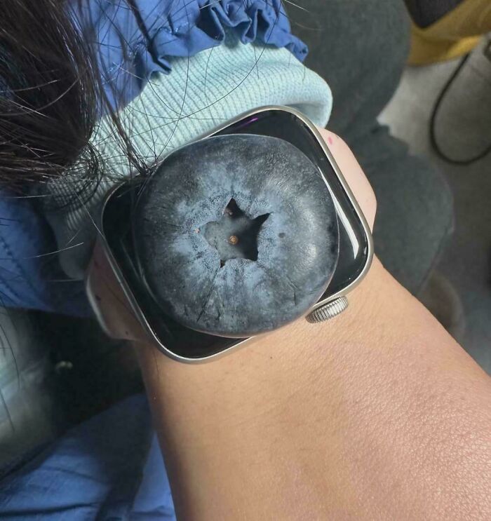 A giant blueberry placed perfectly on an Apple Watch, a quirky sight from the not interesting community.