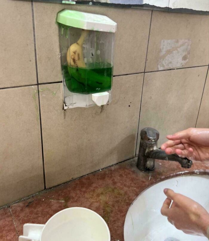 A banana in a soap dispenser above a sink, a peculiar image from the not interesting community.