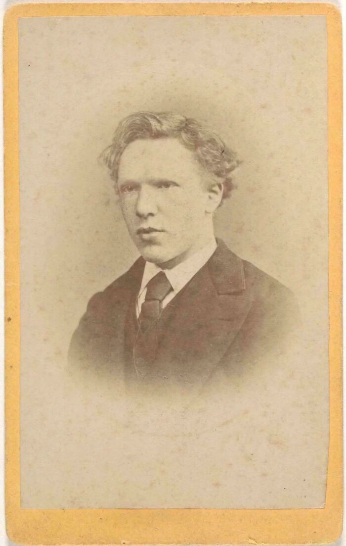 A historical photo of a young Vincent van Gogh, captured in a sepia-toned portrait.