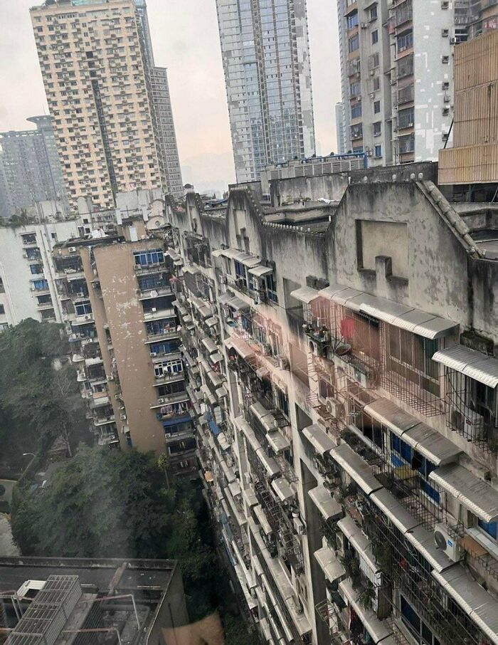 High-rise urban hell apartments with weathered facades and numerous balconies