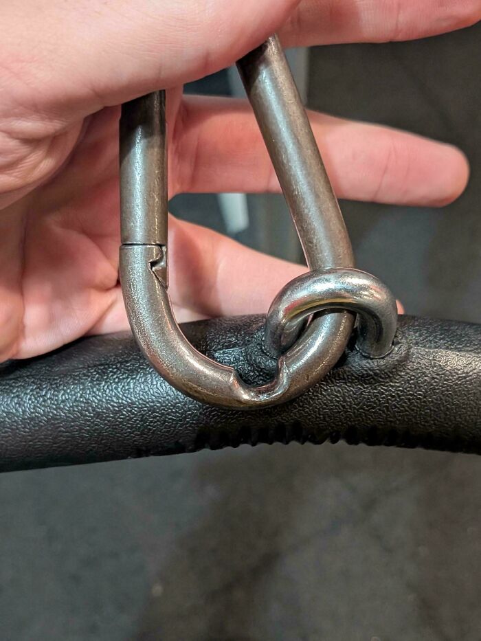 A close-up of a bent and damaged metal clip attached to a black handle, one of the mildly interesting pictures.