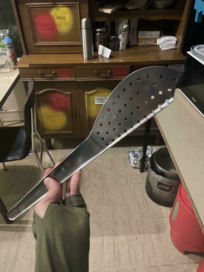 A baffling image of an unusually large slotted spoon, causing people to ask questions about its use.