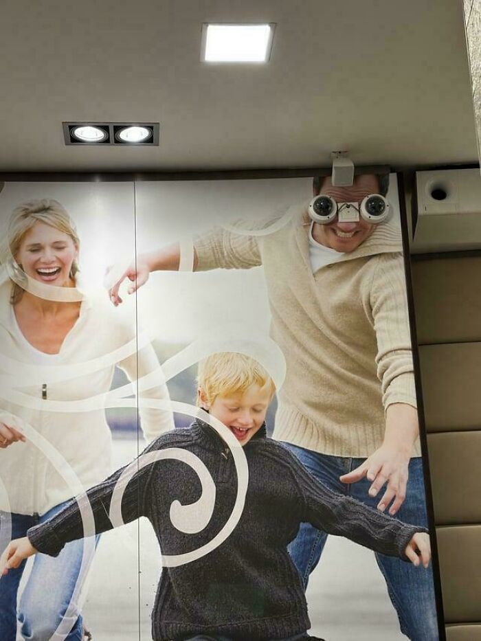 A family advertisement with security cameras strategically placed on the father's face to look like eyes, a peculiar thing spotted.
