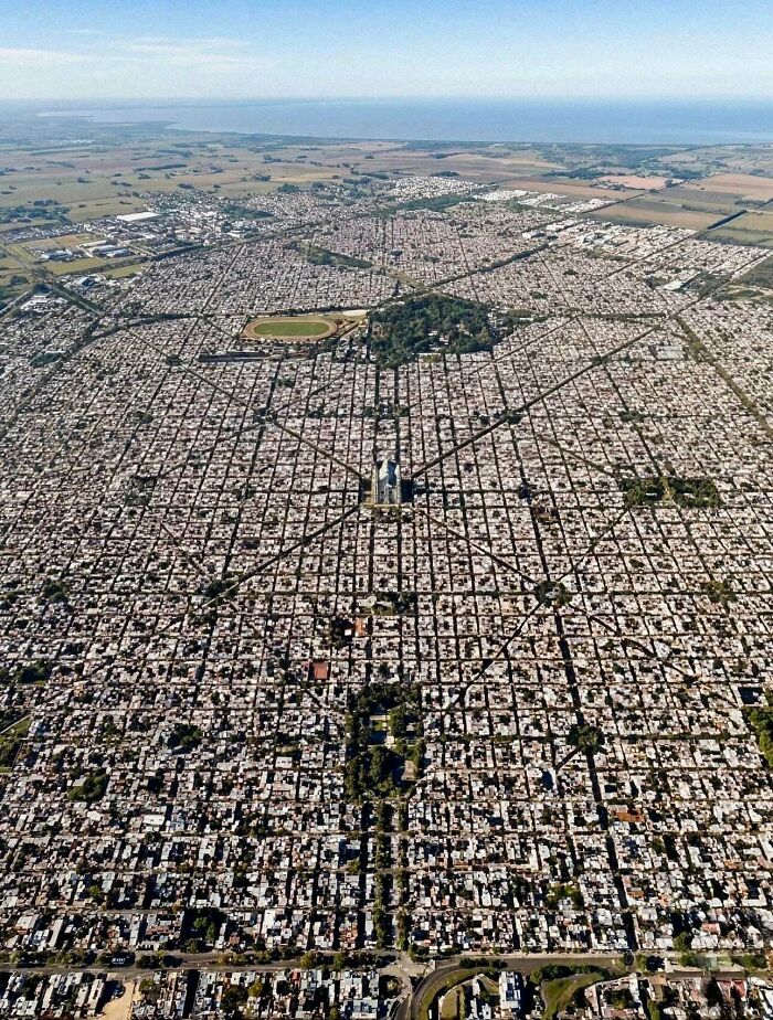An aerial view of a meticulously planned city with a radial street pattern, creating an interesting photo opportunity.