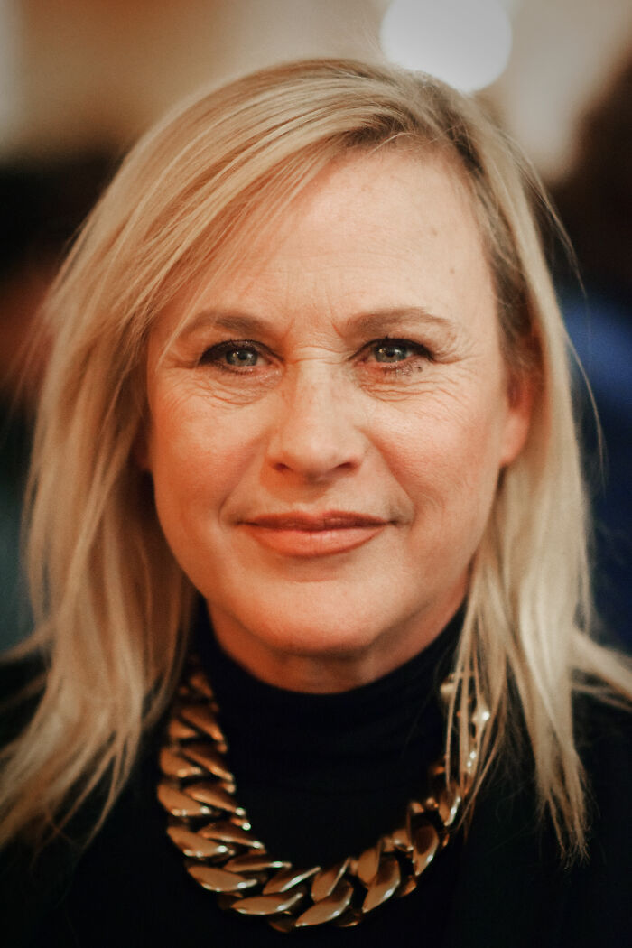 Patricia Arquette close-up portrait, showcasing her natural expression and highlighting her bio and career achievements.