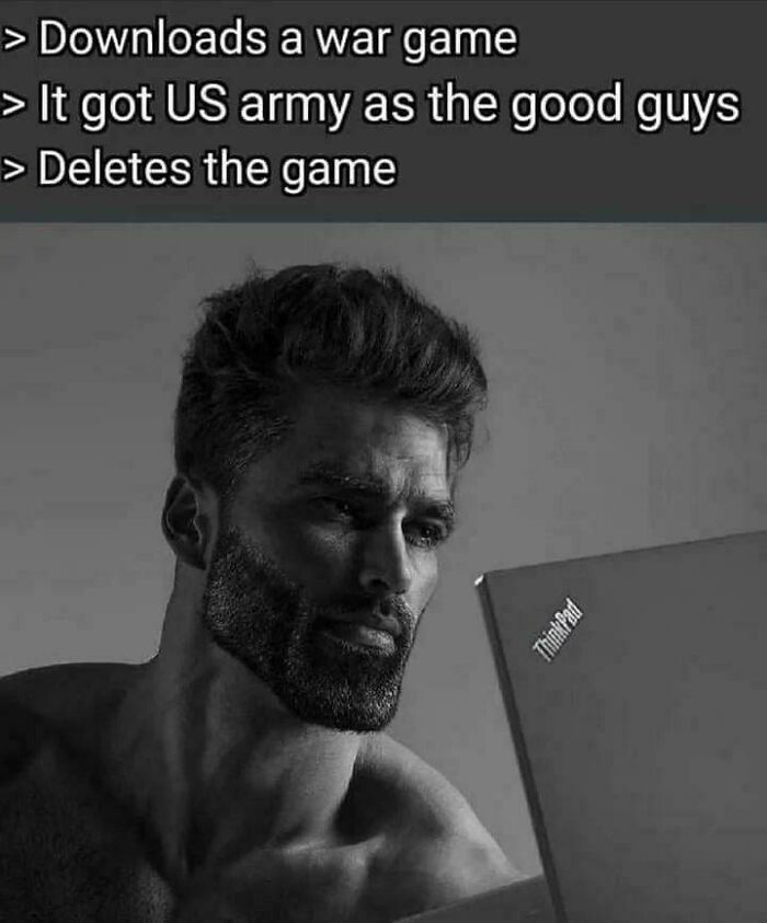 Man with beard looking thoughtfully at laptop screen with war game and US army text about life in America.