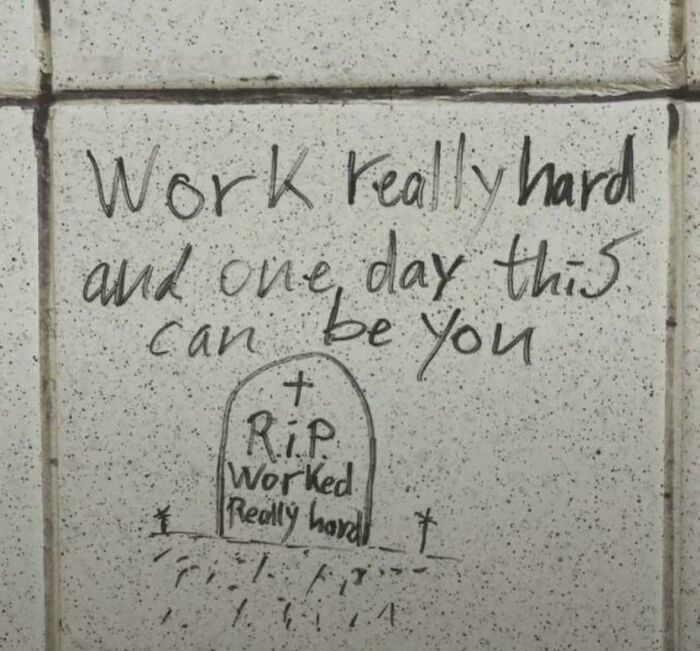 Graffiti on a tiled wall with a message about hard work and life, reflecting themes of life in America.