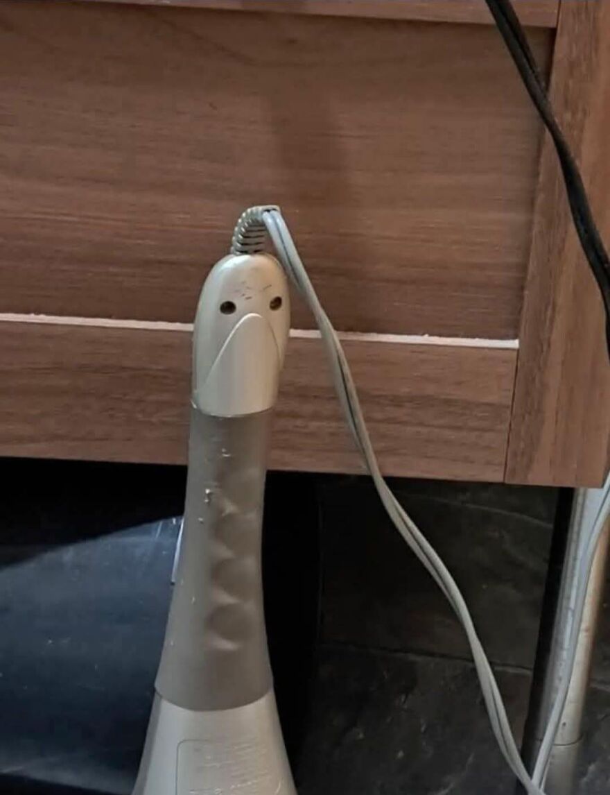 Hand blender with cord and button holes resembling a face, an example of pareidolia captured in a photo.
