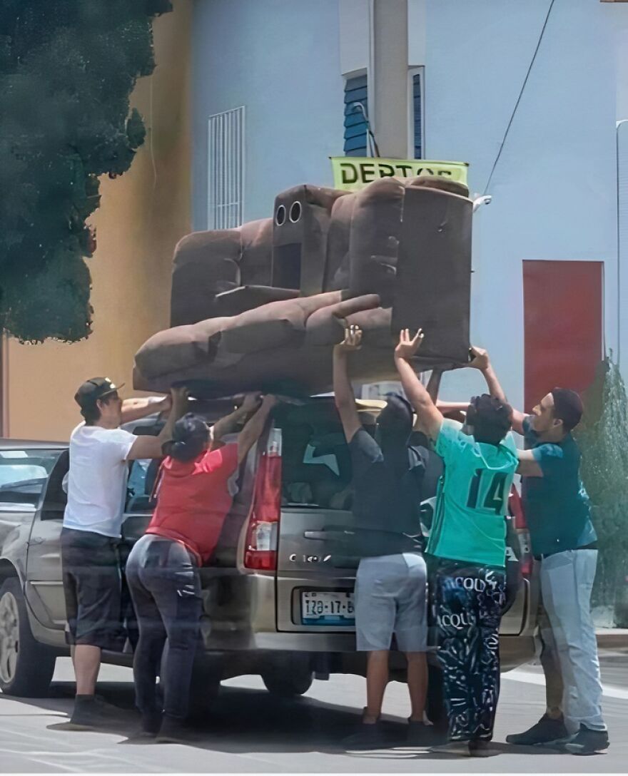 Several people lifting a couch with a face-like pattern onto a car, showcasing pareidolia in everyday objects.