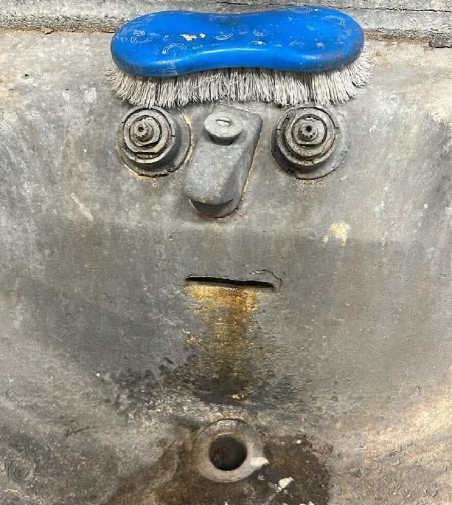 Old metal surface with rust and bolts resembling a face, a common example of pareidolia captured in a photo.
