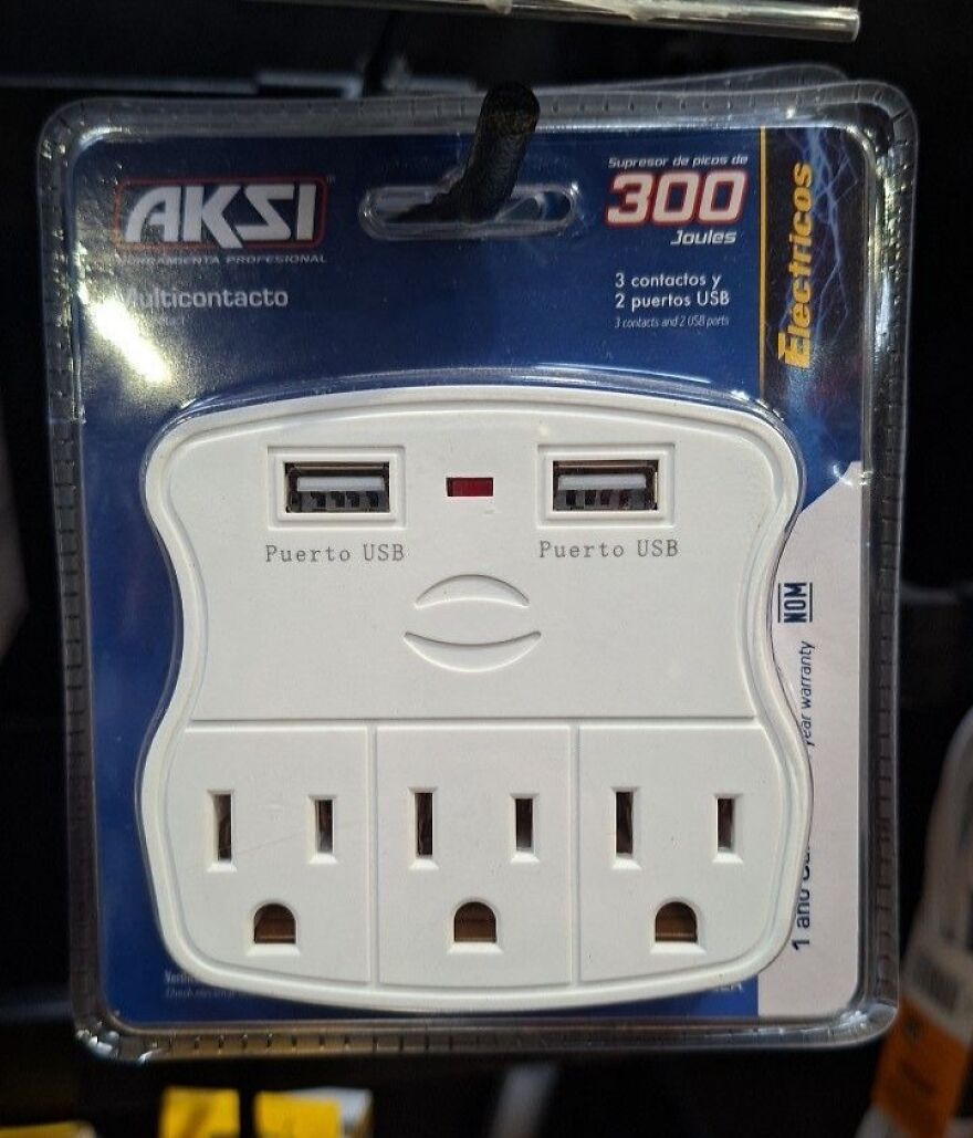 Power outlet and USB ports arranged to resemble a face, an example of pareidolia captured in a product photo.