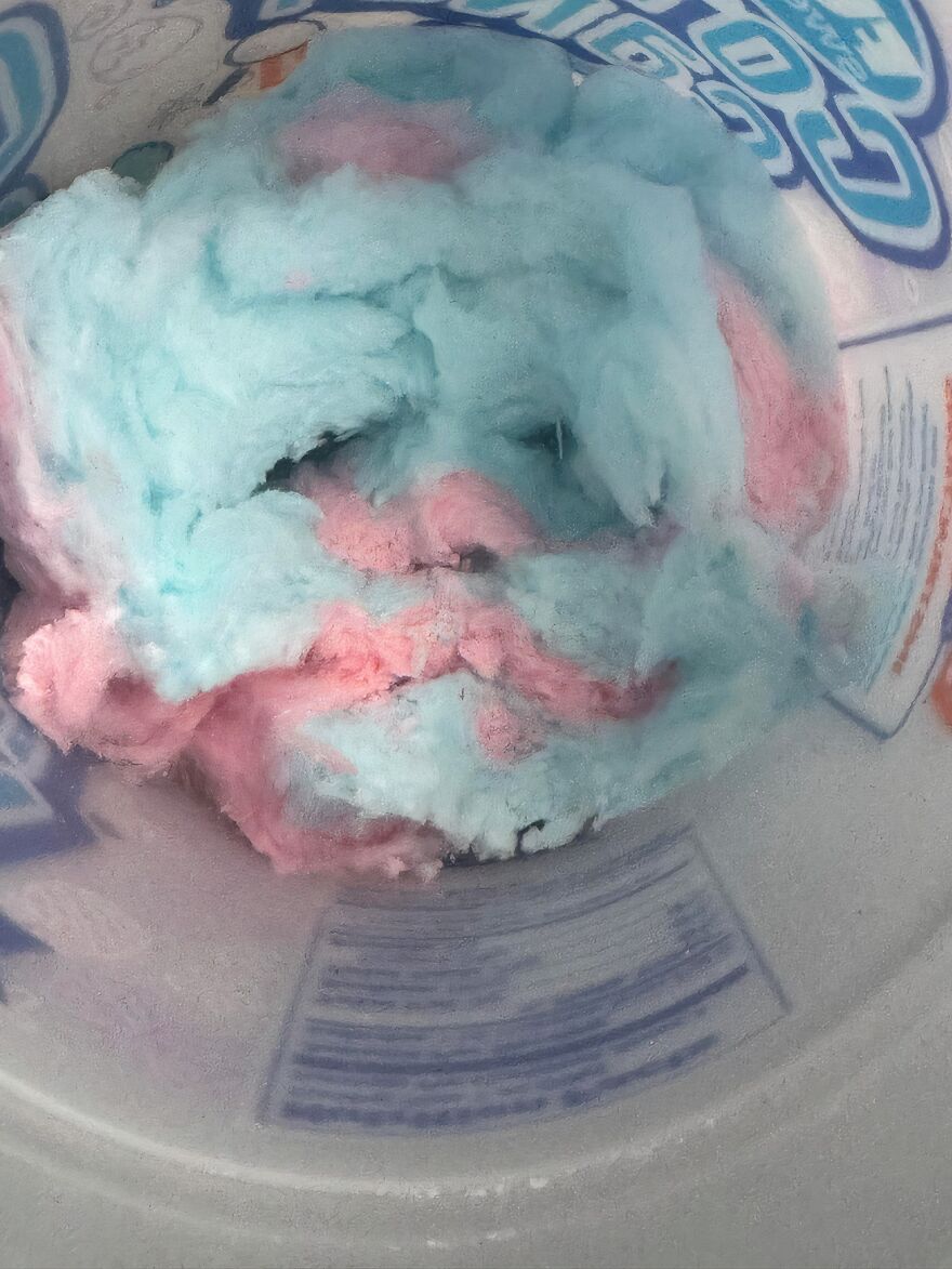 Cotton candy inside a container resembling a human face, an example of pareidolia captured in a photo.