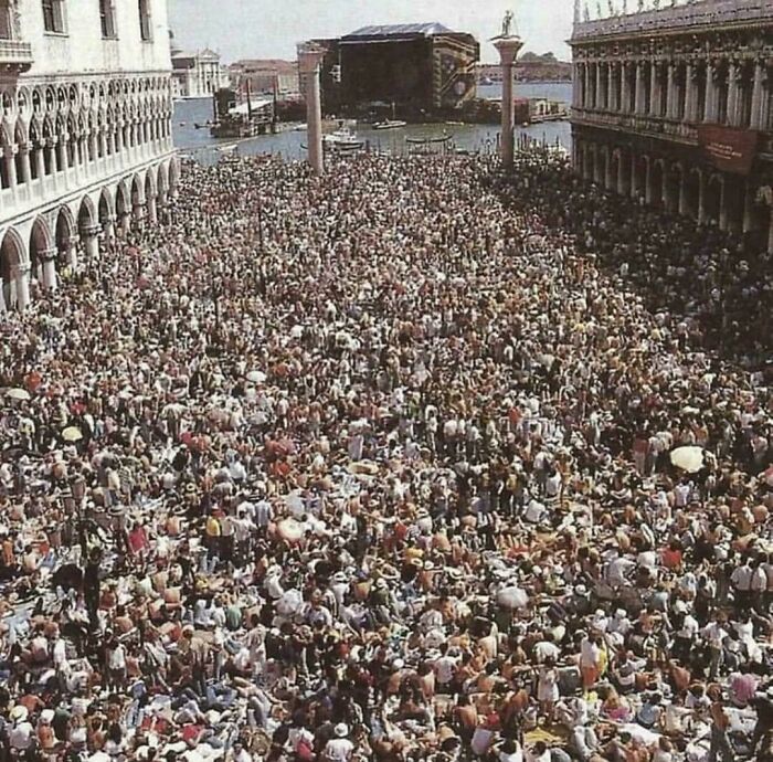 Huge historic crowd gathered in an old city square, illustrating life in a different era with rare and fascinating moments.