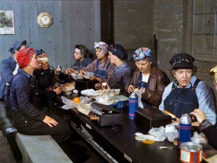 Historic photo of factory workers having lunch together, showcasing life in a different era and rare moments.