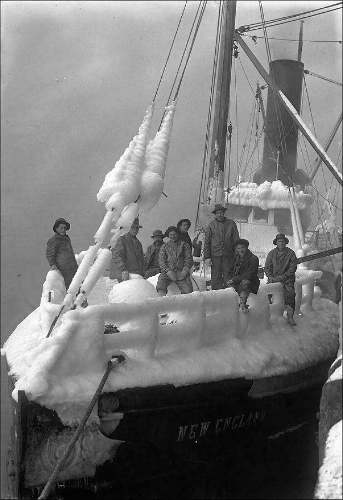 Men on the frozen deck of the ship New England, a rare historic photo showing life in a harsh frozen era.