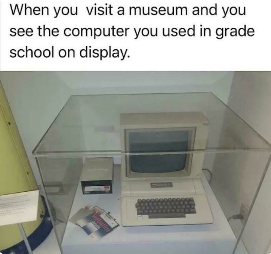 Old 80s computer encased in glass at a museum display, showing technology from parts of our lives that don’t exist anymore.