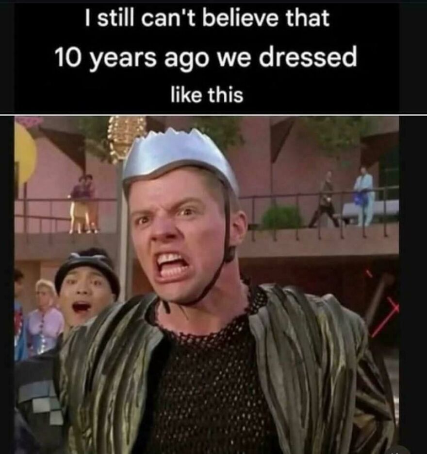 Man in retro ’80s costume with metal helmet and chainmail shirt recalling old fashion trends from past decades