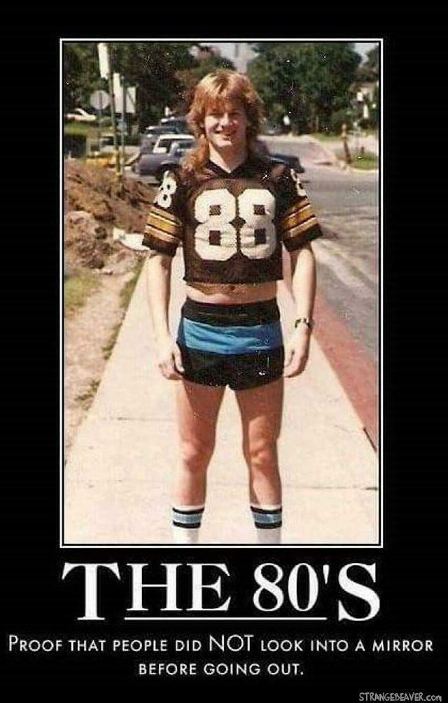 Young man in 80s style cropped football jersey and short shorts on sidewalk, illustrating 80s life moments that don’t exist anymore.