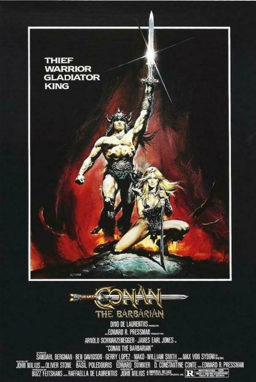 1980s Conan the Barbarian poster showing warrior and female fighter with swords and fiery background.