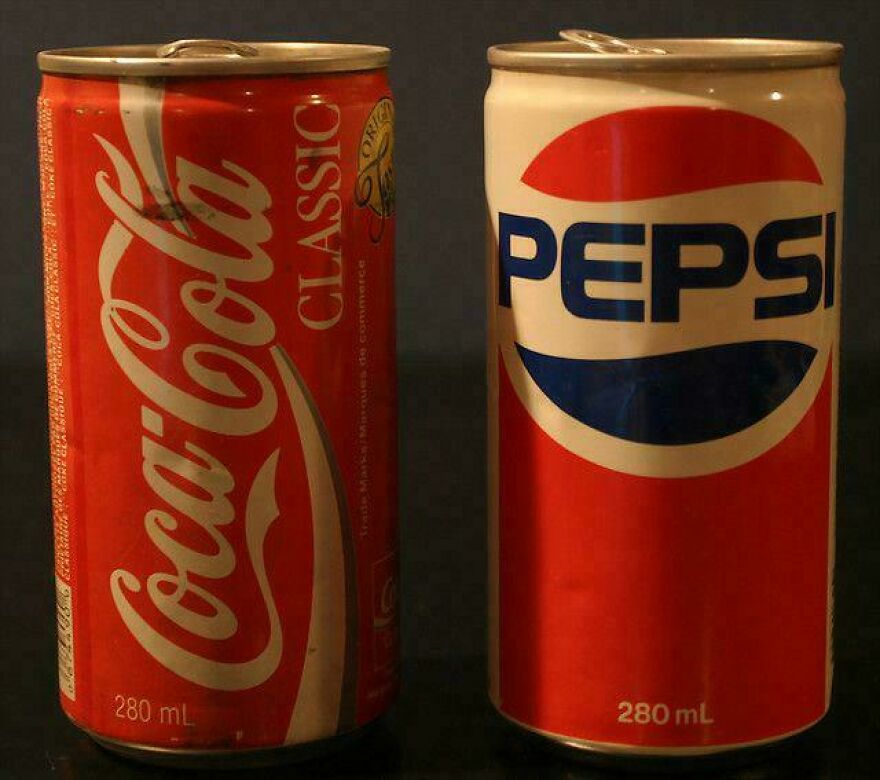 Vintage Coca-Cola Classic and Pepsi soda cans from the 80s representing parts of our lives that don’t exist anymore
