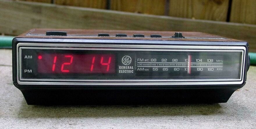 Vintage General Electric digital clock radio with red LED display and analog FM-AM tuner, representing 80s technology nostalgia.
