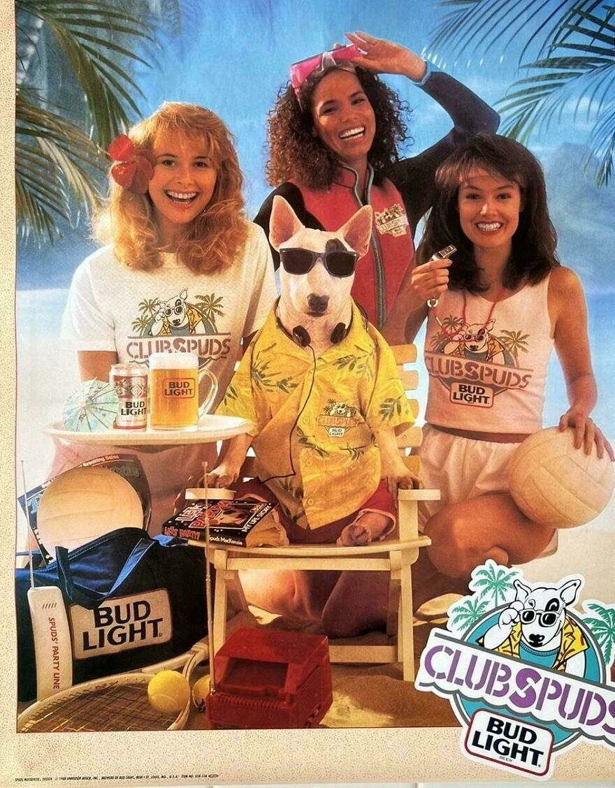 Three women and a dog in '80s summer attire posing with Bud Light cans, volleyball, and retro beach accessories.