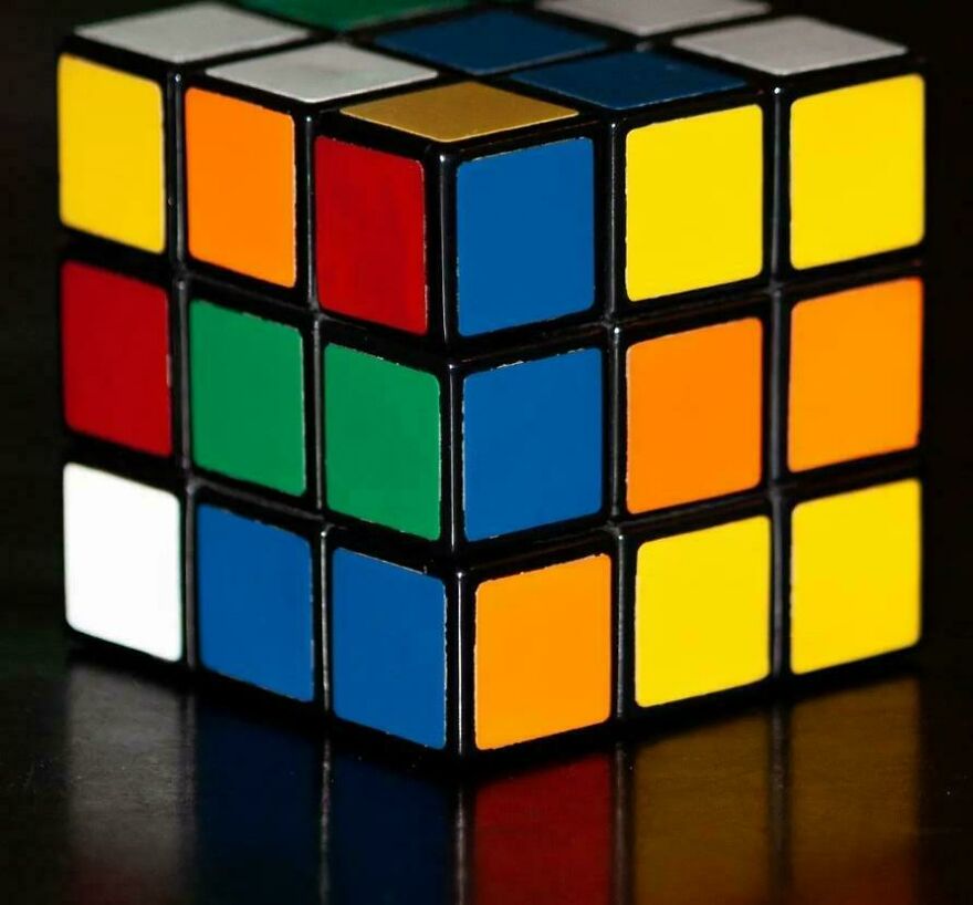Partially solved Rubik's Cube on a dark surface, representing nostalgic 80s moments and parts of our lives that don’t exist anymore.