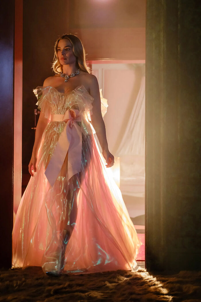 Margot Robbie in a sheer pink gown, highlighting nonsensical movie details.