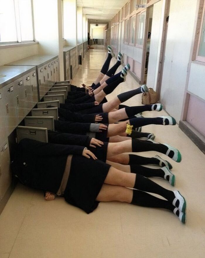 Students in creative poses lying on the floor with legs raised, showcasing hilarious and creative poses perfectly pulled off.