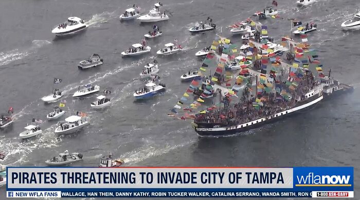 Large pirate ship surrounded by smaller boats in water, with a headline about pirates threatening to invade Tampa.