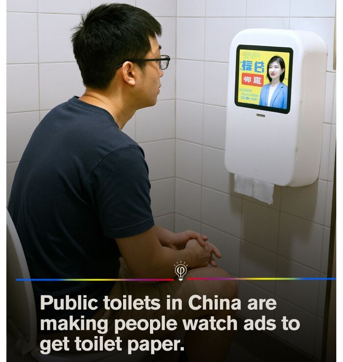 Man sitting in a public toilet watching ads on a screen to get toilet paper, illustrating modern depressing posts.