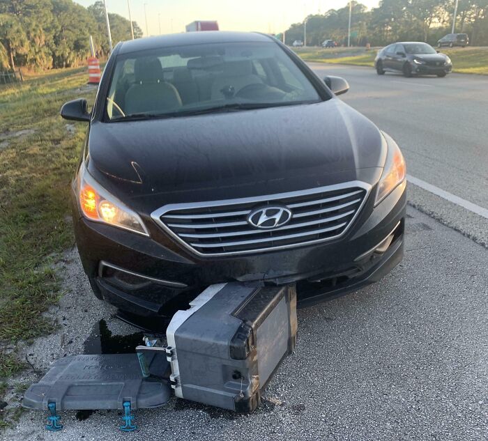 Black Hyundai car on roadside after collision with broken equipment, illustrating gut warnings about something horrible incidents.