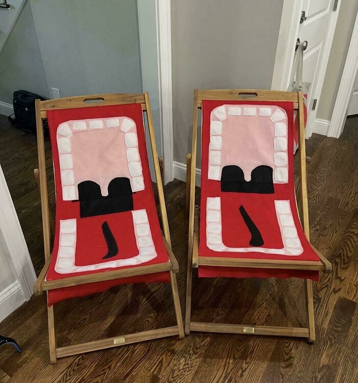 Two matching handmade projects deck chairs, each designed to look like a person's open mouth with teeth and a tongue, displayed indoors.