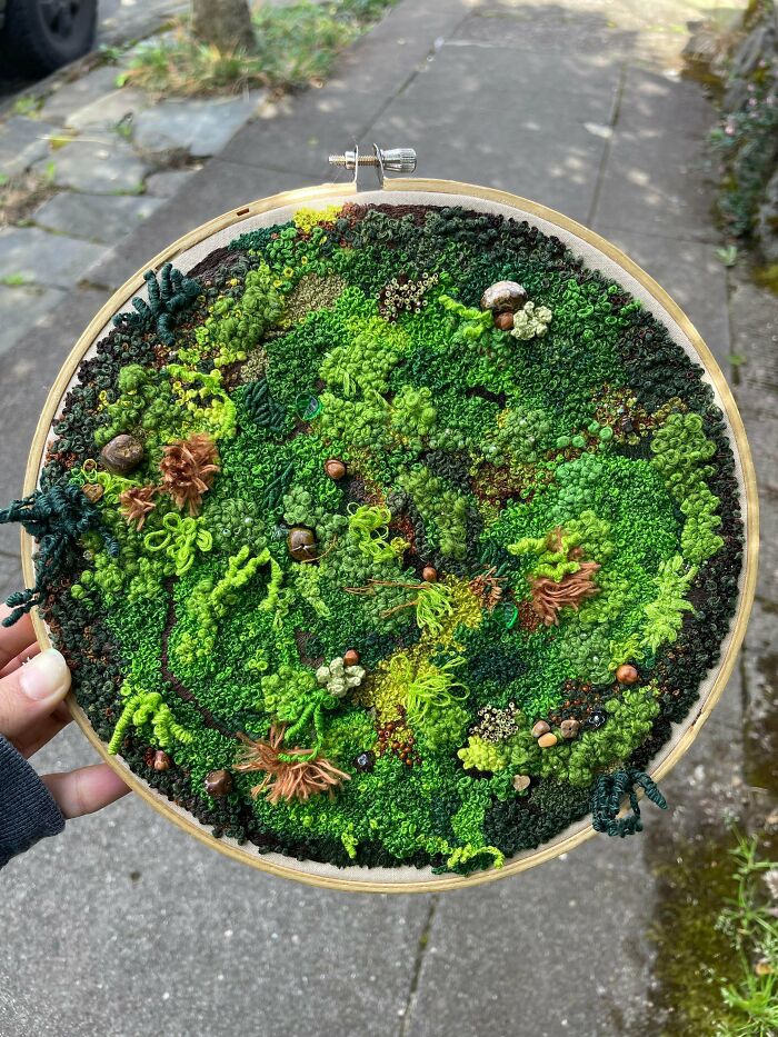 Stunning embroidery creation of a detailed moss landscape with tiny mushrooms, inspiring a new hobby.