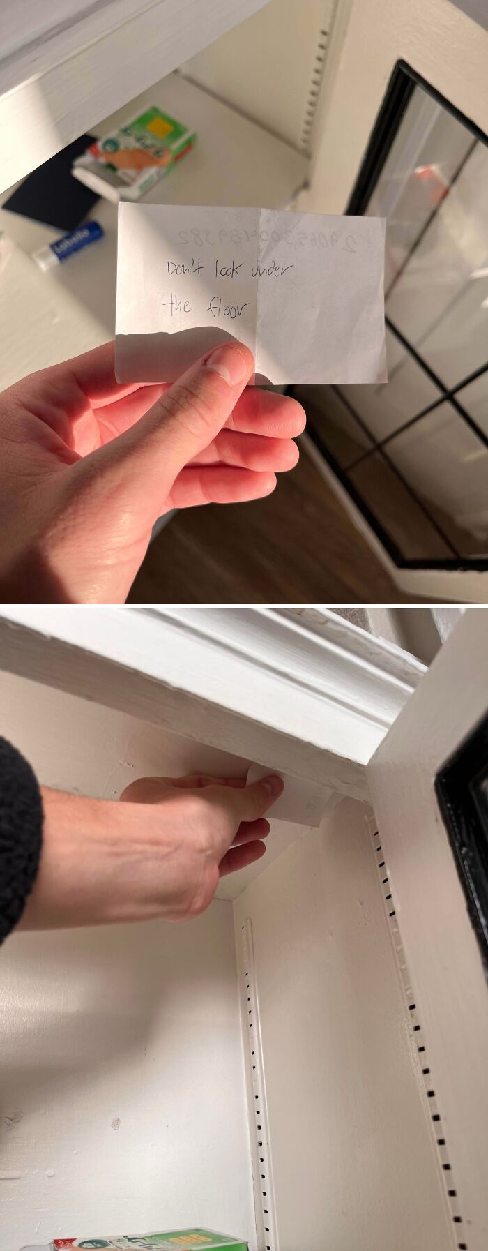 Hand holding a creepy note saying "Don't look under the floor" inside a white cabinet for spooky photo content.