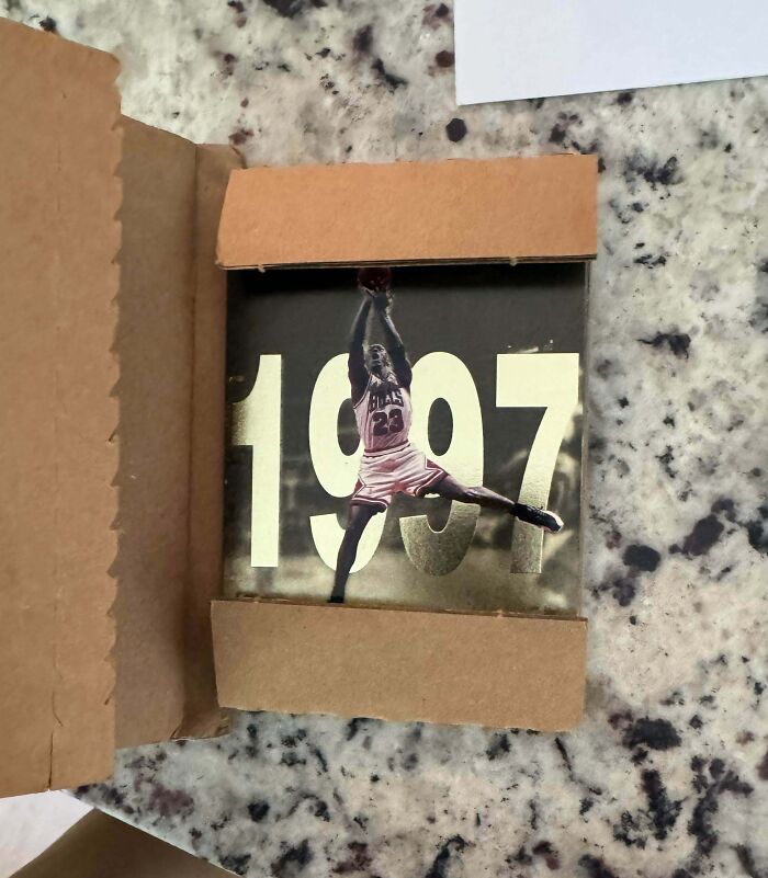 Photo of a vintage basketball card partially wrapped in cardboard, highlighting true colors of friends interactions online.